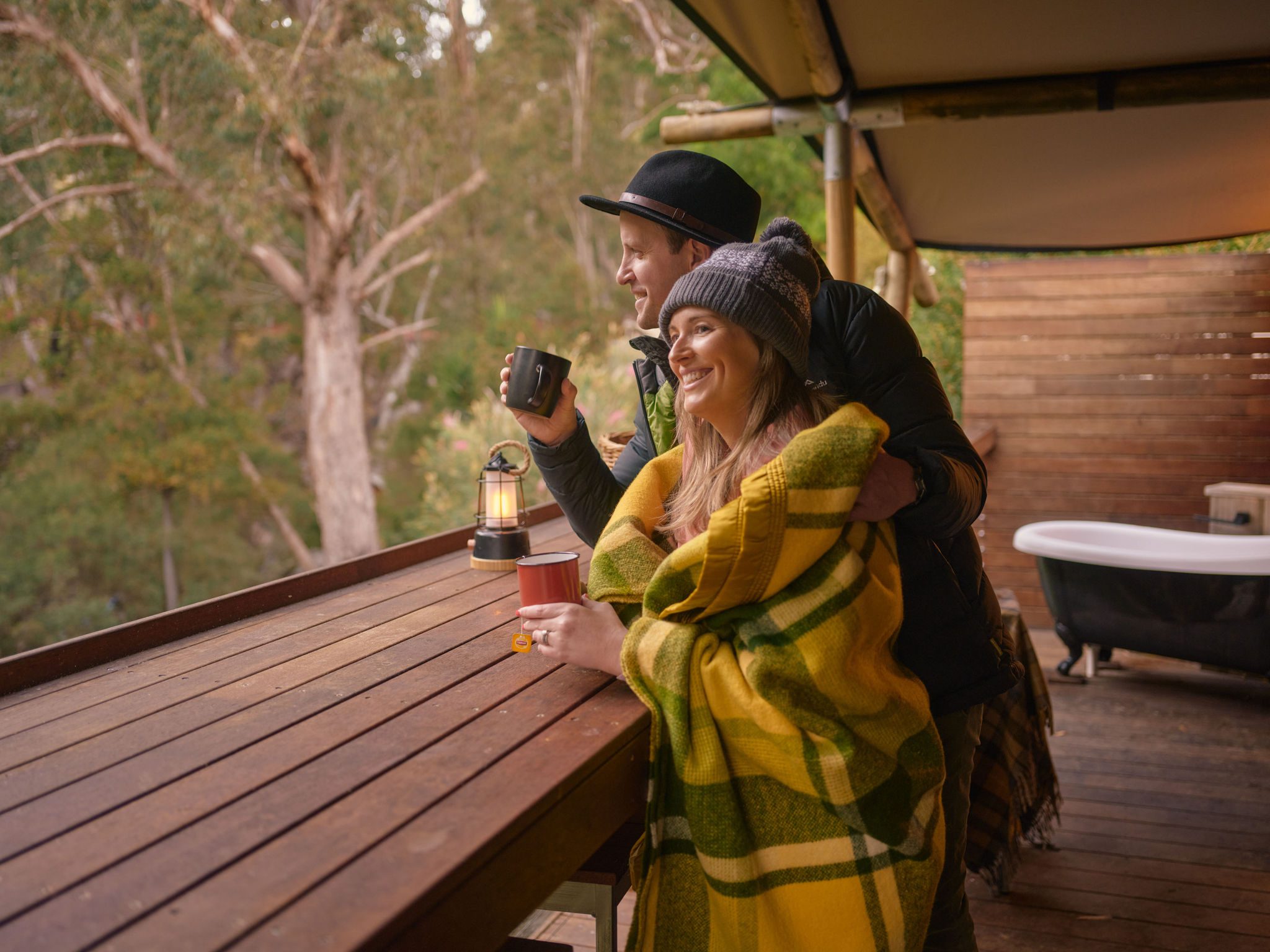 Couple relaxing together outside their glamping tent in the Grampians
